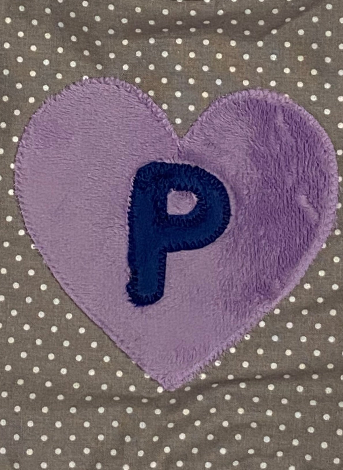 Tiny dot bib with navy blue initial and purple heart